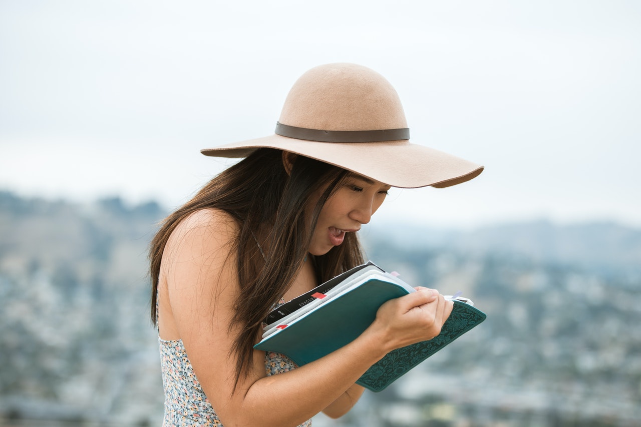 mladá žena čítajúca knihu počas krásneho letného dňa