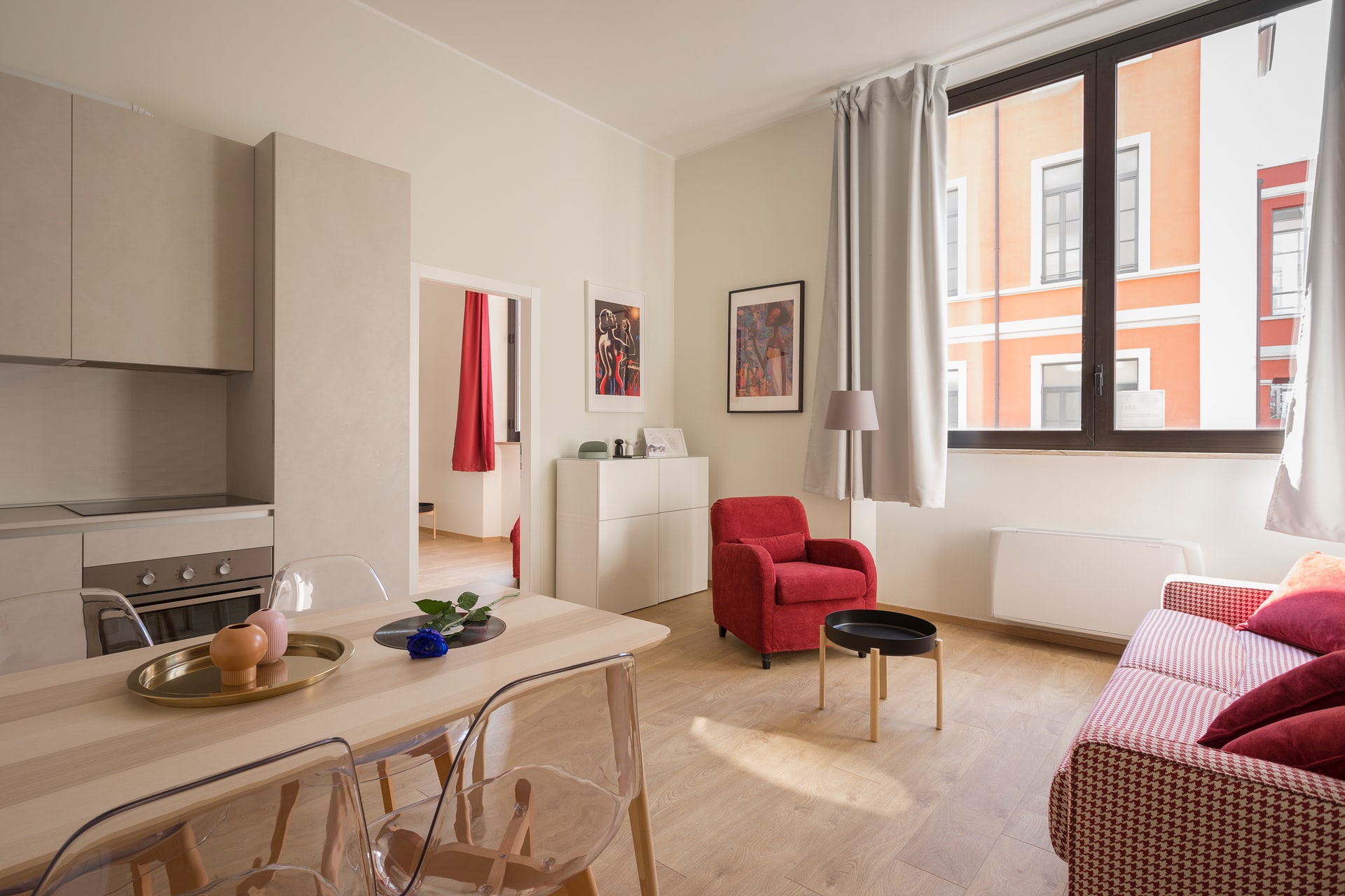 esteticky a moderne zariadený byt s červeným kreslom a dreveným nábytkom